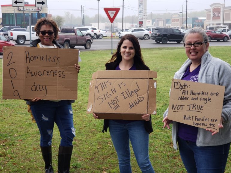 Picture of people holding cardboard signs